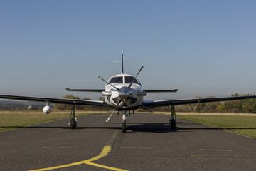 Private small single turboprop aircraft on airport runway