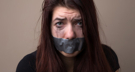Frightened girl hostage with tape