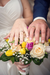 Obraz na płótnie Canvas Hands with wedding rings and bouquet. Keep calm and said I Do