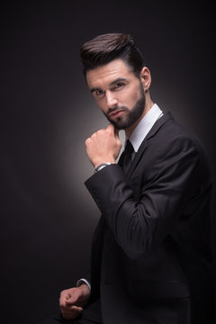 young man posing handsome suit elegant, black background