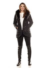 young woman in winter clothes on white background