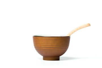 A bowl and a wooden spoon isolated over white background