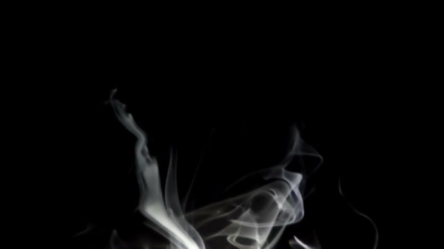 white sidestream smoke rise in the dark