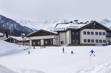 People with children on skis at home.
