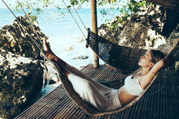 Woman relaxing in hommack on the beach