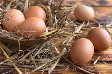 Brown eggs in the straw close-up in a rustic style