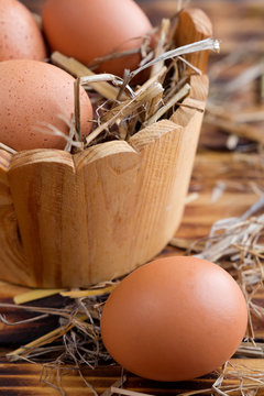 Brown eggs in the straw close-up in a rustic style