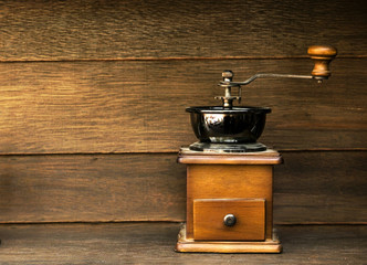 Vintage Coffee grinder on wood background.