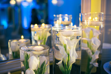 The vases  with candles stand on the buffet table