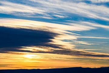 Fototapeta premium Beautiful Sunset Cloudy Sky Over Mountains