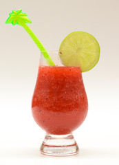 Strawberry cocktail in round glass with slice of lime