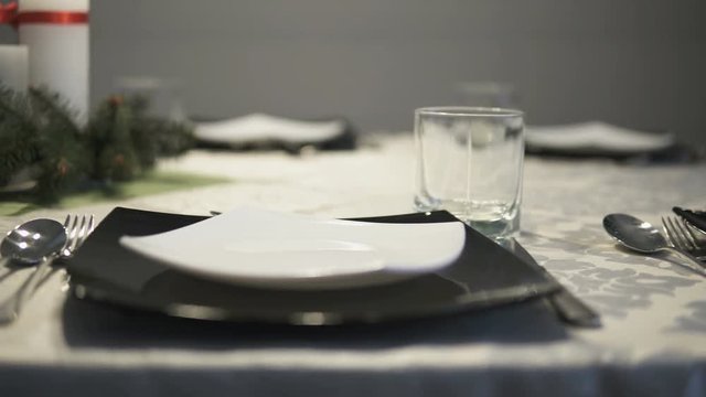 Camera slide over untouched table setting before elegant dinner during holidays