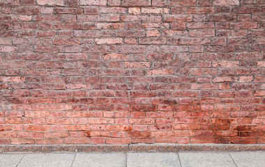Red brick wall and concrete floor