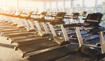 Modern gym interior with equipment, treadmills for fitness cardio training