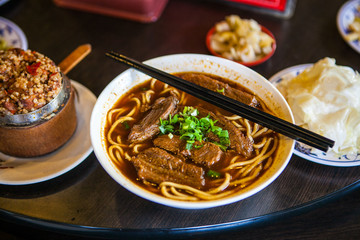 Asian beef noodle soup stew in restaurant chopsticks