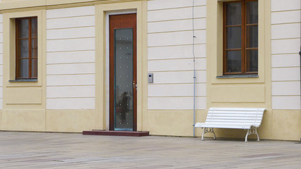 Bench in front of the wall of the building