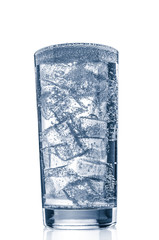 Sparkling mineral water with ice in glass on white background