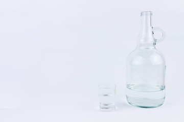 Object photography of a shot glass and a bottle of vodka