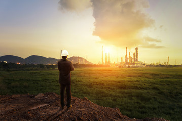 Engineer standing at oil refinery, Power and energy crisis concept
