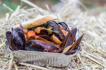 Mussels served with vegetables in foil box