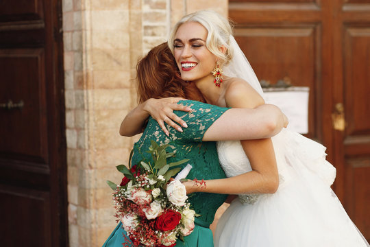 Warm Hugs Of Blonde Bride And Her Mother In Green Gown