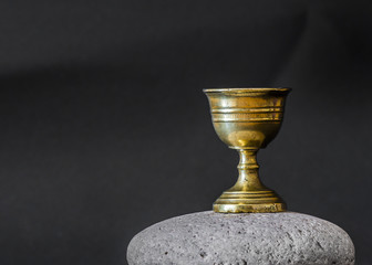 Old chalice on stone