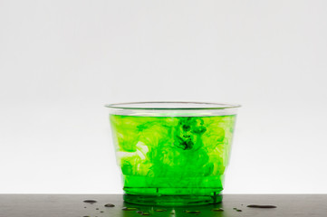Green color water drop in white background.