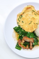 Stir fried kale with crispy pork and Thai Omelette with rice in white dish iIsolated on white background, Thai Food