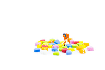 Miniature people working on heart isolated on white background