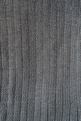 Close-up of seamless gray knitted fabric texture.