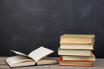 Education concept - books on the desk in the auditorium