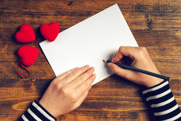 Woman writing love letter for Valentines day - obrazy, fototapety, plakaty
