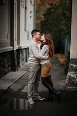 Naklejka premium Young couple wearing on tied warm sweaters hugging in love under
