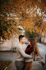 Fototapeta premium Young couple wearing on tied warm sweaters hugging in love at ci