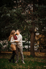 Fototapeta premium Young couple wearing on tied warm sweaters hugging in love at ci