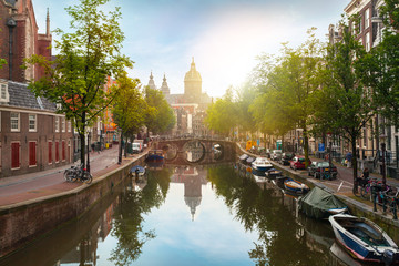 Houses and Boats on Amsterdam Canal. Morning photo of colored houses in the Dutch style with reflection in water