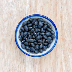  Vigna mungo in bowl on wood floor background.