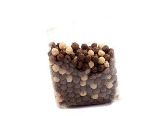 Falling flakes breakfast cereal isolated on white background. Healthy breakfast.