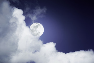 Naklejka na ściany i meble Attractive photo of a nighttime sky with clouds, bright full moon would make a great background. Nightly sky with large moon. Beautiful nature use as background. Outdoors.
