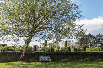 Obraz premium Shady Park Bench in the French Garden of Eyrignac in Salignac