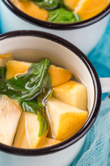 Cup of tea with apples and basil