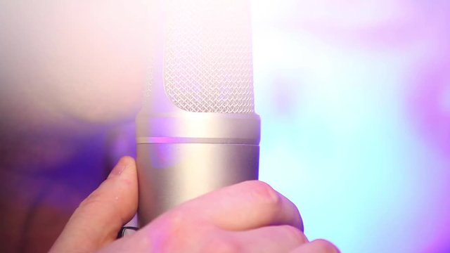 Darkened singer sings into a microphone