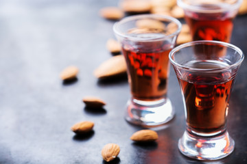 Almond liquor amaretto on a grunge black table