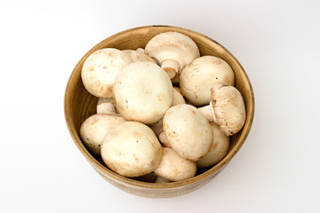 mushrooms in a bowl on a white background