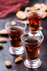 Almond liquor amaretto on a grunge black table