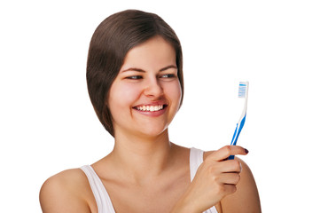Woman with toothbrush smiling, isolated over white background.