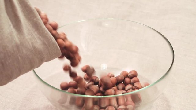 Hazelnut poured out of the sack into glass bowl