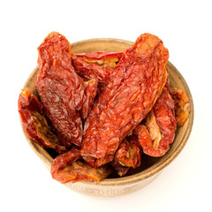 dried tomatoes in a bowl on a white background