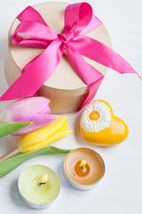 Pink yellow tulips and gift box with red ribbon