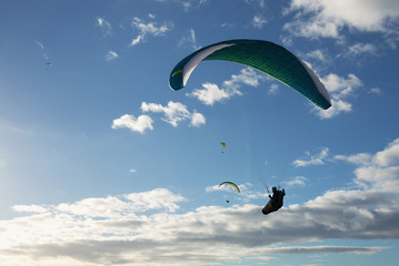 Group of paragliding flying in the blue sky